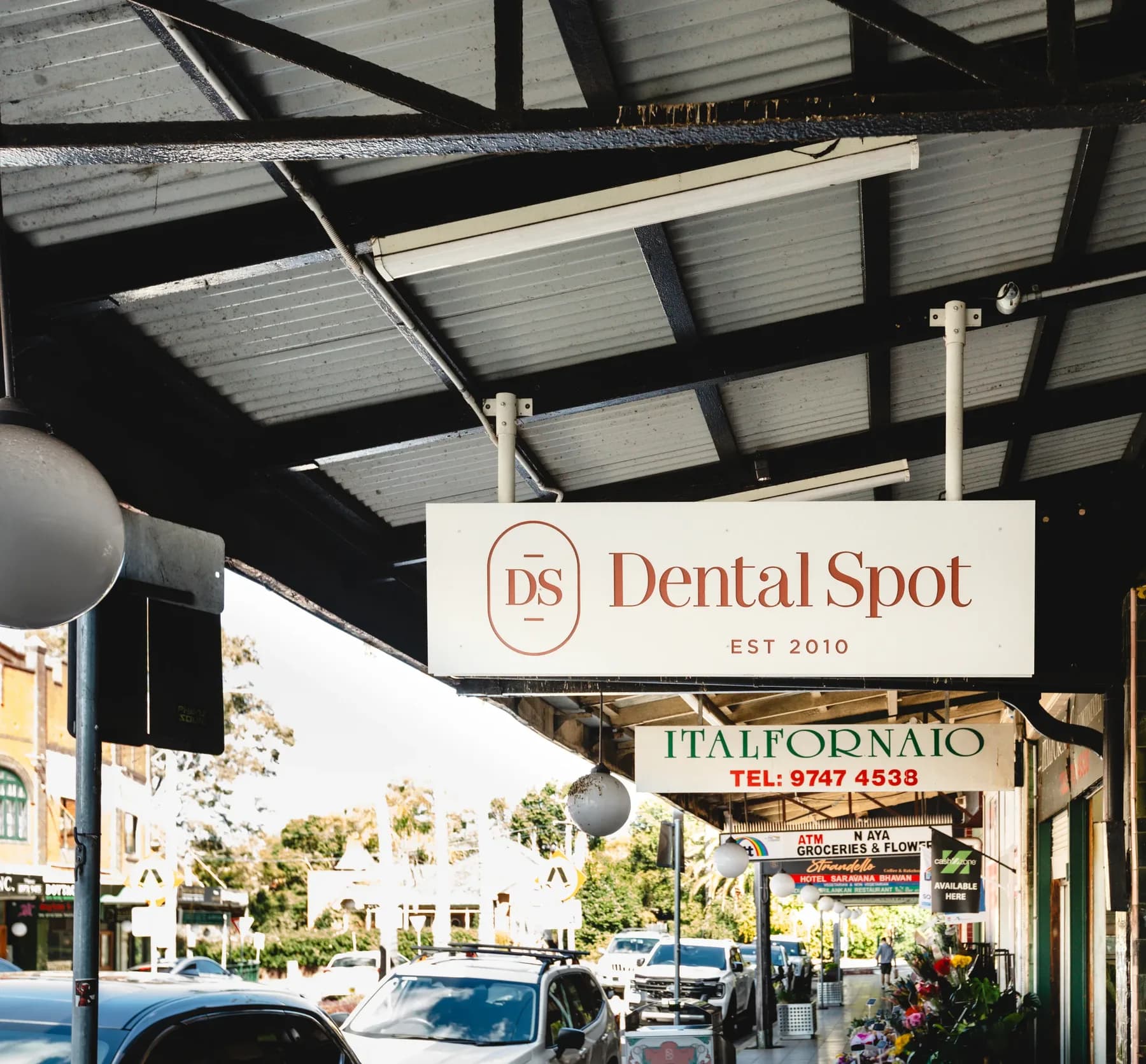 The Dental Spot sign over the footpath on The Strand, Croydon